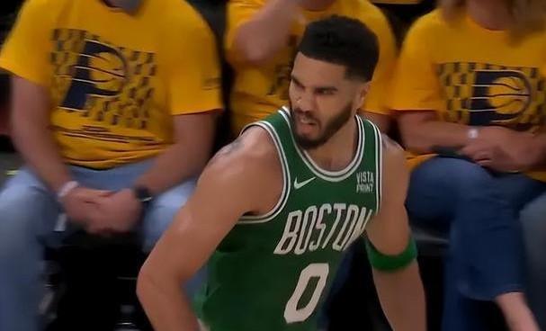 A basketball player in a green jersey Description automatically generated