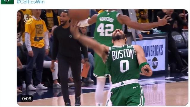 A basketball player in green jersey with a ball in his hand Description automatically generated