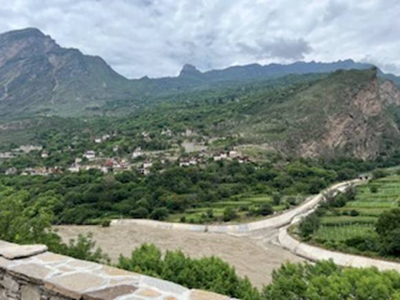 A landscape with a road and mountains